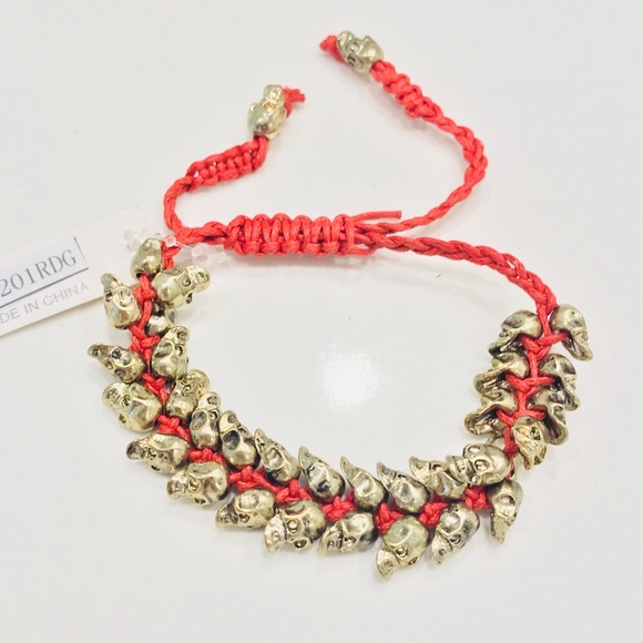 Jewelry - NWT bracelet, multiple bronze skulls & red thread